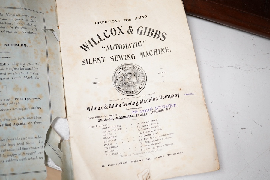 A late 19th century Willcox & Gibbs Automatic Silent Sewing Machine, with its instruction booklet and pine case. Condition - good.